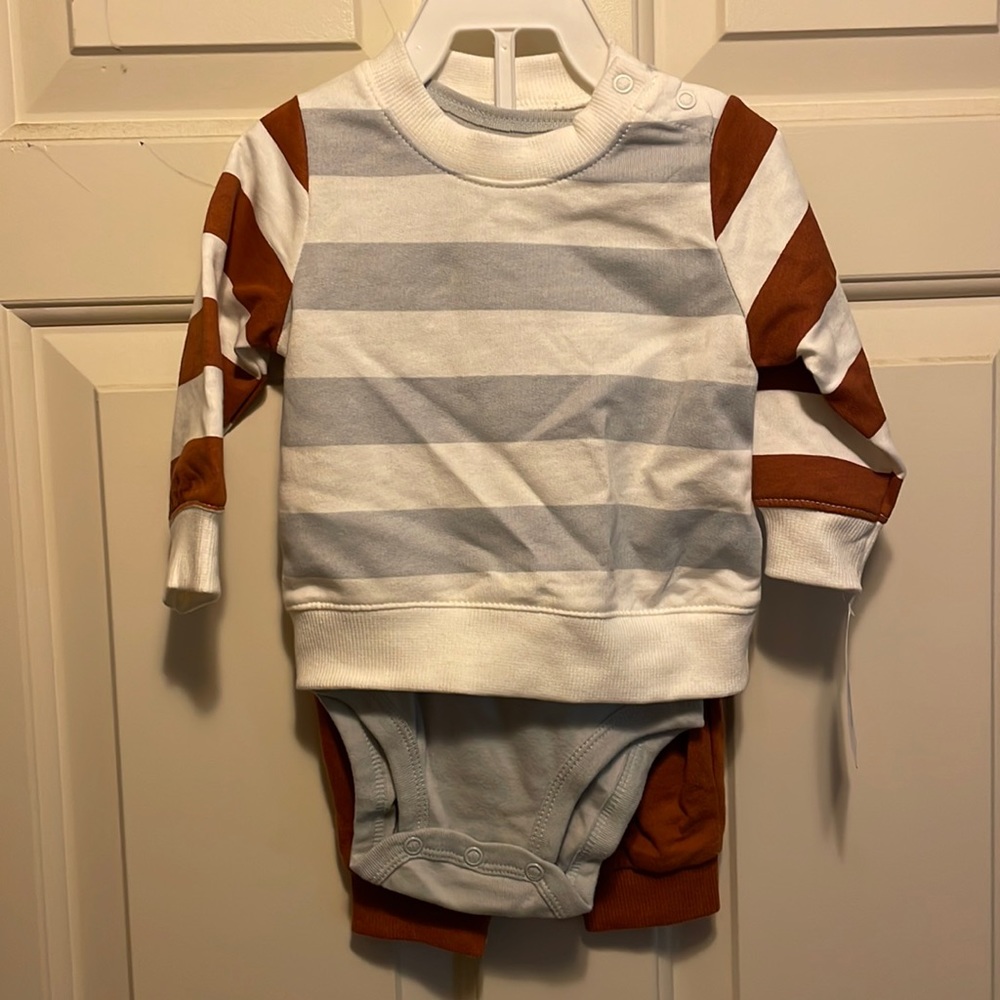 3 piece outfit with sweatshirt, short sleeve gray onesie, and orange pants